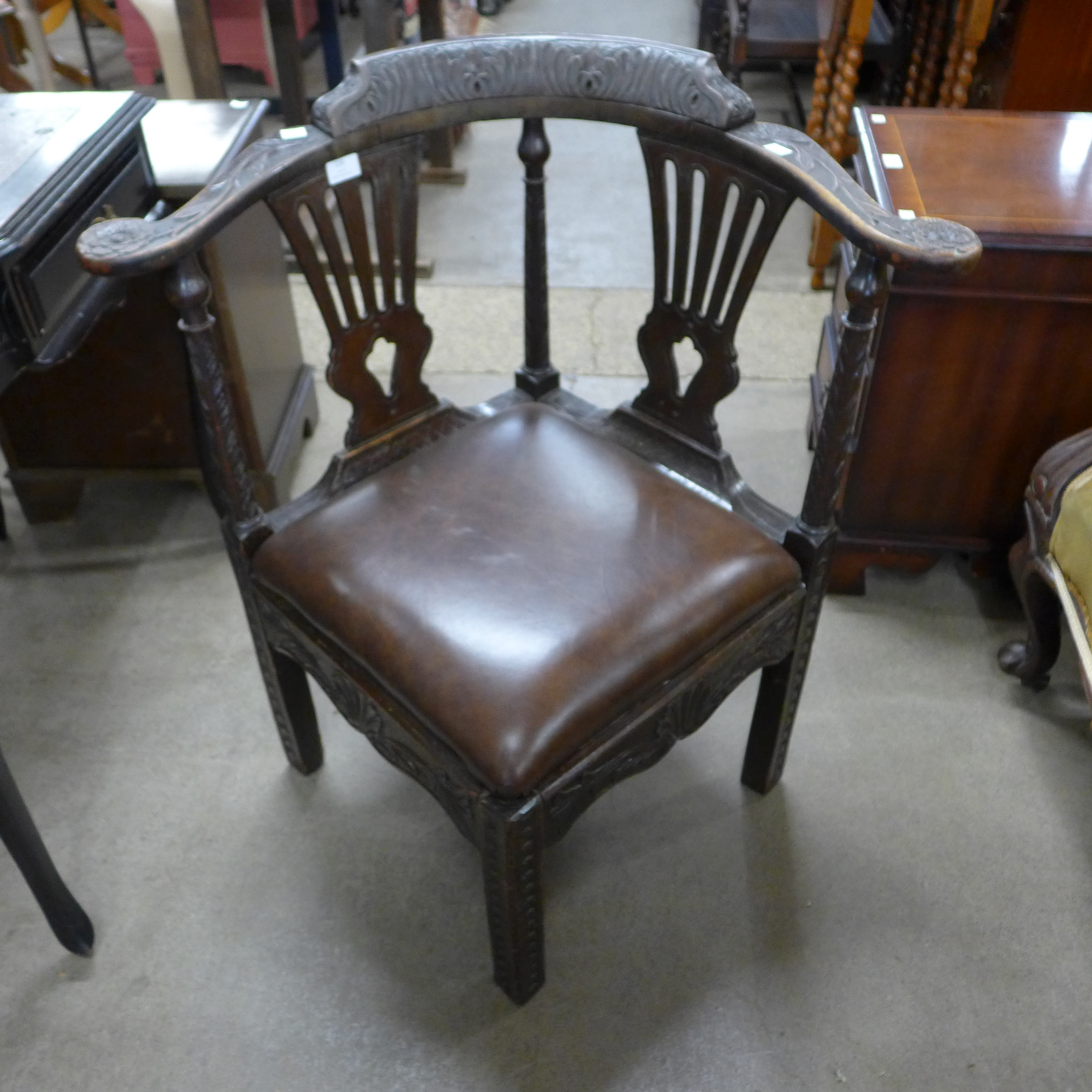 A George III carved corner chair