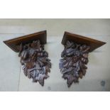 A pair of 19th Century Black Forest carved softwood wall brackets