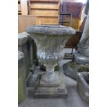 A pair of reconstituted stone garden urns