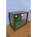 An oak table top display cabinet