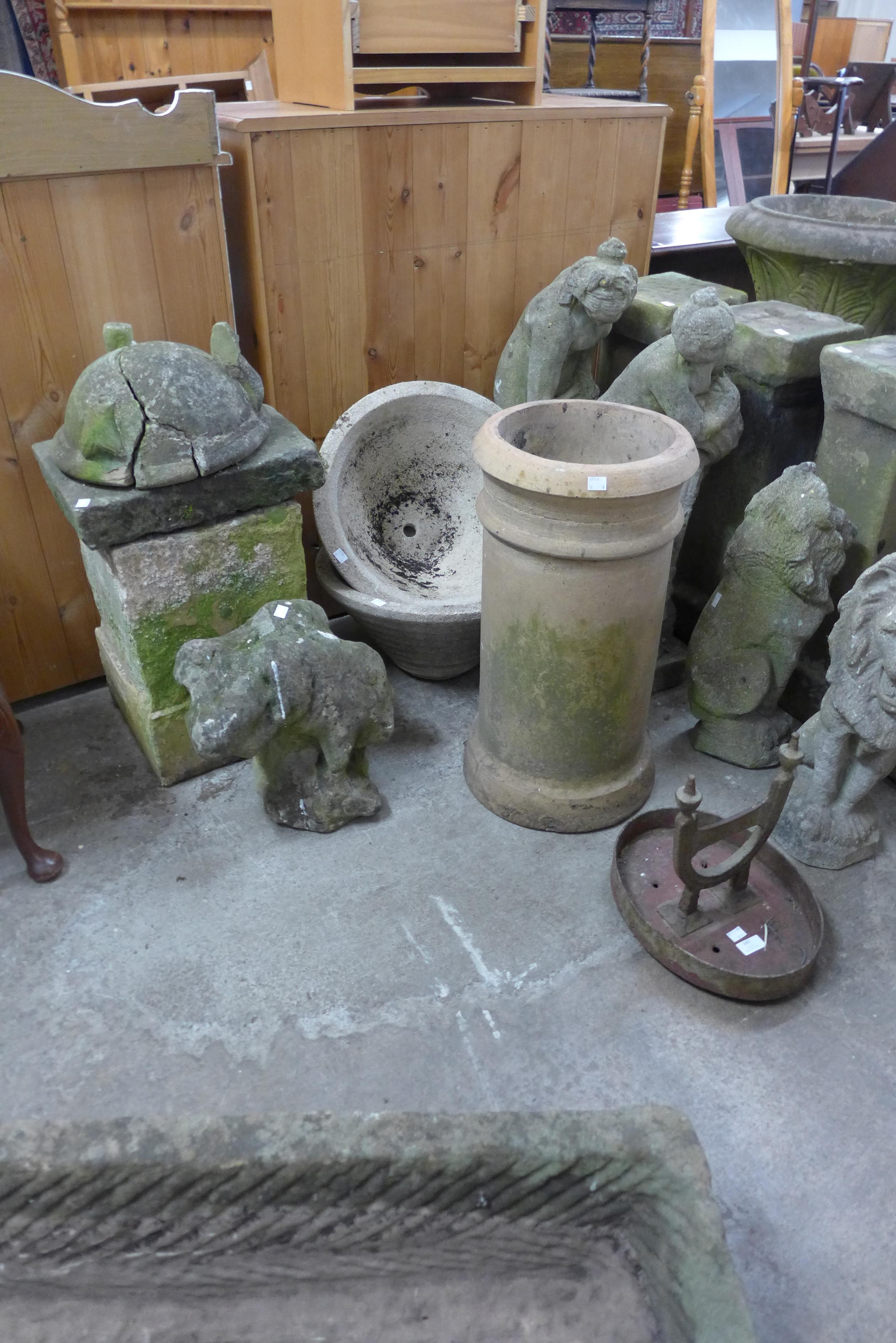 A cast iron boot scraper, a terracotta chimney pot, a pair of concrete planters, etc.