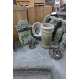 A cast iron boot scraper, a terracotta chimney pot, a pair of concrete planters, etc.