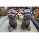 A pair of Chinese painted concrete garden dogs of foe