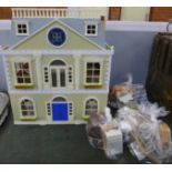 A large plastic doll's house with furniture