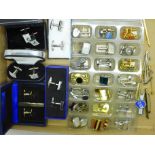 A collection of cufflinks and tie pins