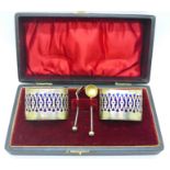 A pair of late Victorian silver salts with liners and matching spoons, 43.5g without liners, cased