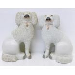 A pair of 19th Century Staffordshire pottery poodles, one a/f