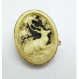 A Victorian 9ct gold memorial brooch with carved stag decoration, width 27mm