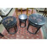 A Chinese black lacquered chinoiserie circular nest of tables