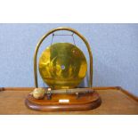 A WWI brass trench art gong, on an oak stand, with striker