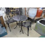 A painted metal three piece bistro set