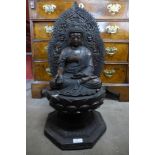 A large oriental bronze figure of a seated deity