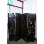 A Chinese black lacquered chinoiserie folding dressing screen