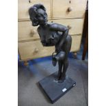 A large bronze figure of a female nude holding a jug