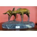 A bronze figure of two deer, on green marble plinth