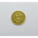 A Peruvian 1920 1/5th De Libra gold coin, 1.6g