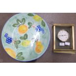 A heavy brass and glass mantel clock and a large bowl