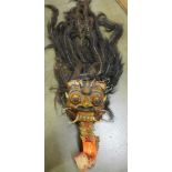 A carved Tibetan mask with real hair piece