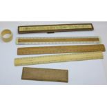 Assorted ivory, bone and wooden rulers and a napkin ring