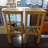 A pair of oak laboratory stools