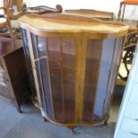 A walnut single door display cabinet