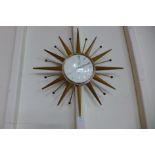 A Smiths teak and brass sunburst wall clock