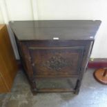 A 17th Century style carved oak credence cupboard