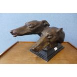 A bronzed bust of two greyhounds