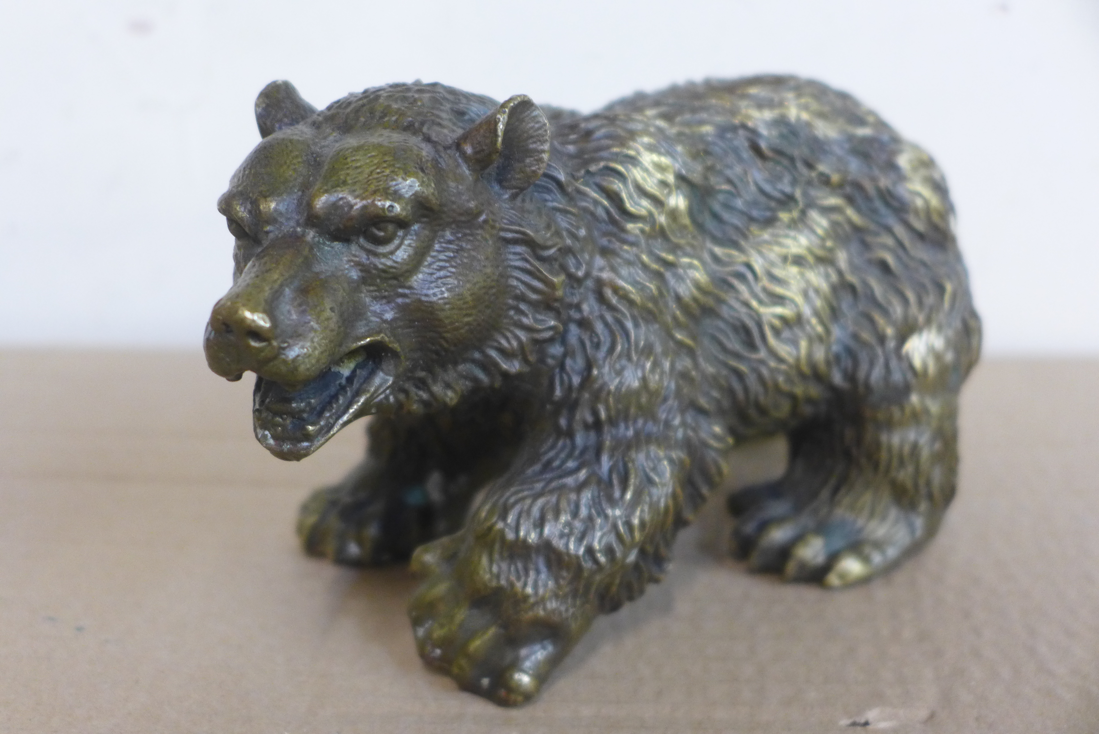 A small bronze figure of a grizzly bear