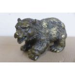 A small bronze figure of a grizzly bear