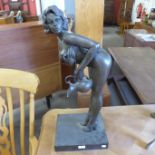 A large bronze figure of a female nude holding a jug