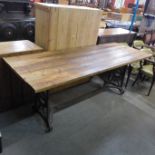 A large industrial style cast steel and pine topped table