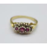 A 9ct gold, three ruby and eighteen diamond cluster ring, 1.8g, O