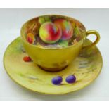 A hand painted Royal Worcester cup and saucer, the saucer signed W H Austin and the cup signed R