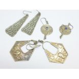 Three pairs of silver and white metal earrings