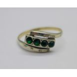 A 9ct gold and silver ring set with green stones, Q