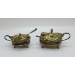 Two silver mustard pots with blue glass liners, one by Walker & Hall, Birmingham 1918, and one by