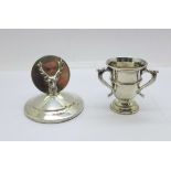 A silver stag menu holder, William Hutton & Sons Ltd, Sheffield 1937 and a small silver trophy,