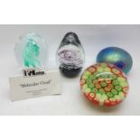 Four glass paperweights including one handmade Molecular Cloud by Kenleys