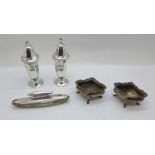 A pair of silver salt and pepper pots, two silver salts and a silver mounted buffer by