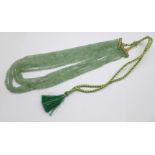 A green aventurine gemstone bead necklace with textile thread