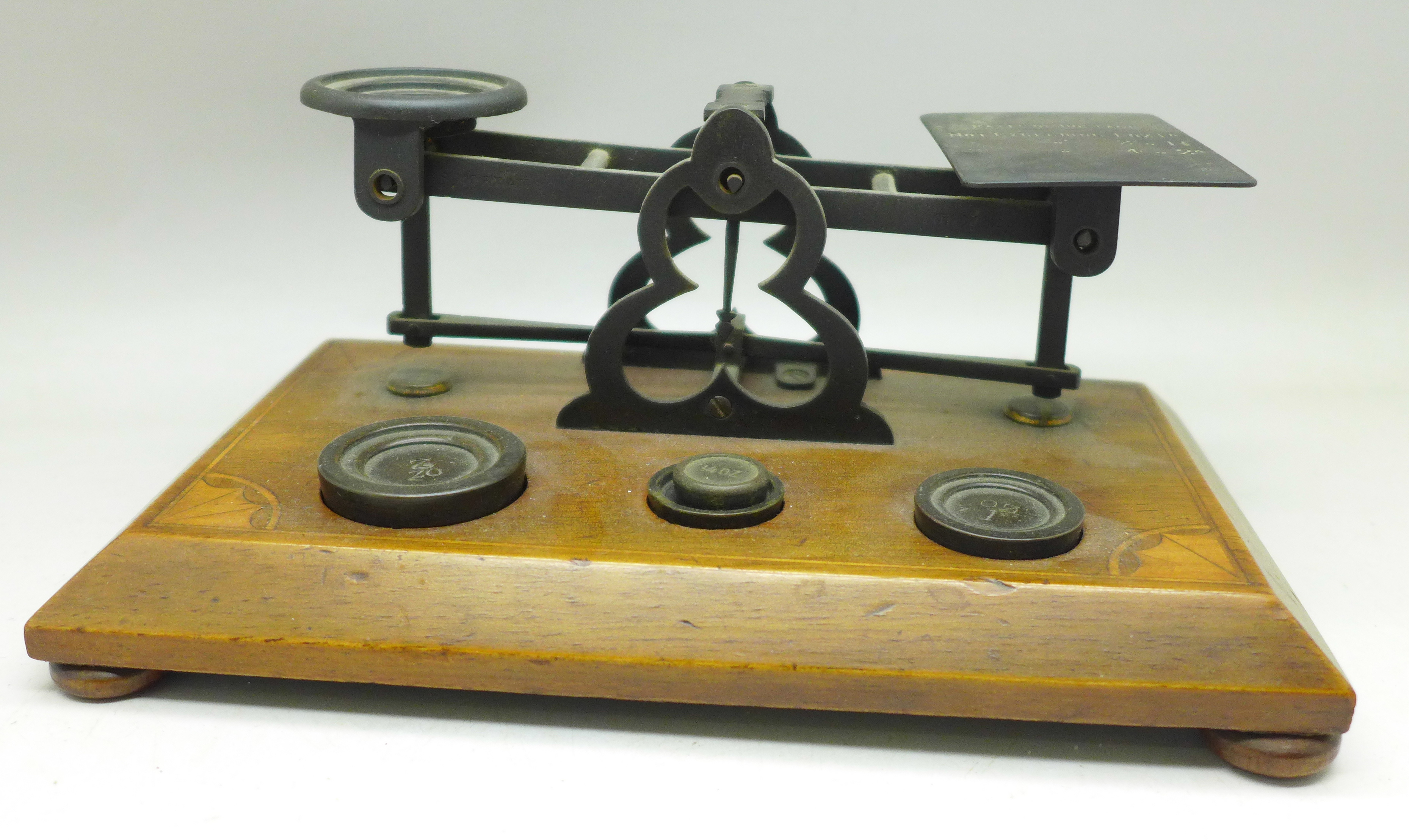 A set of Edwardian postal scales and weights with inlaid wooden base