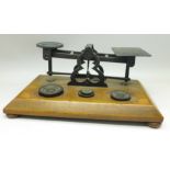 A set of Edwardian postal scales and weights with inlaid wooden base