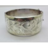 A wide hallmarked silver bangle, 55g