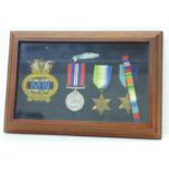 A set of mounted WWII medals with Atlantic and 1939-1945 Star and Merchant Navy cloth badge