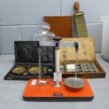 Pharmaceutical equipment including two weighing scales, one in a travel case with weights, a pill