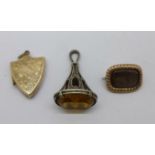 A 19th Century mourning brooch, a shield shaped locket and a seal fob, loop a/f