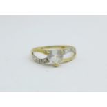 A 9ct gold heart shaped ring with a small diamond set on each shoulder, 1.1g, O