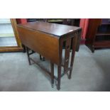 An Arts and Crafts oak drop leaf table