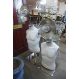 A pair of male torso mannequins, converted to lamps